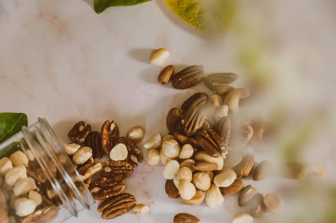 Nuts spilling from a glass jar